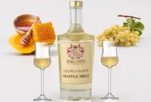 Box degustazione con tre bottiglie di grappa artigianale aromatizzata al miele di Millefiori Borgunto - distillato toscano in elegante confezione regalo