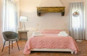 Camera da letto king size con letto rosa e travi in legno - Suite King Allegra Toscana Arezzo
