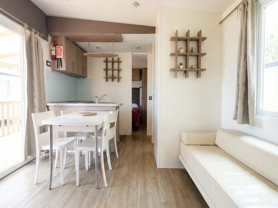 zona-giorno-bungalow-menta-arezzo Zona giorno del bungalow Menta con cucina, tavolo da pranzo e divano